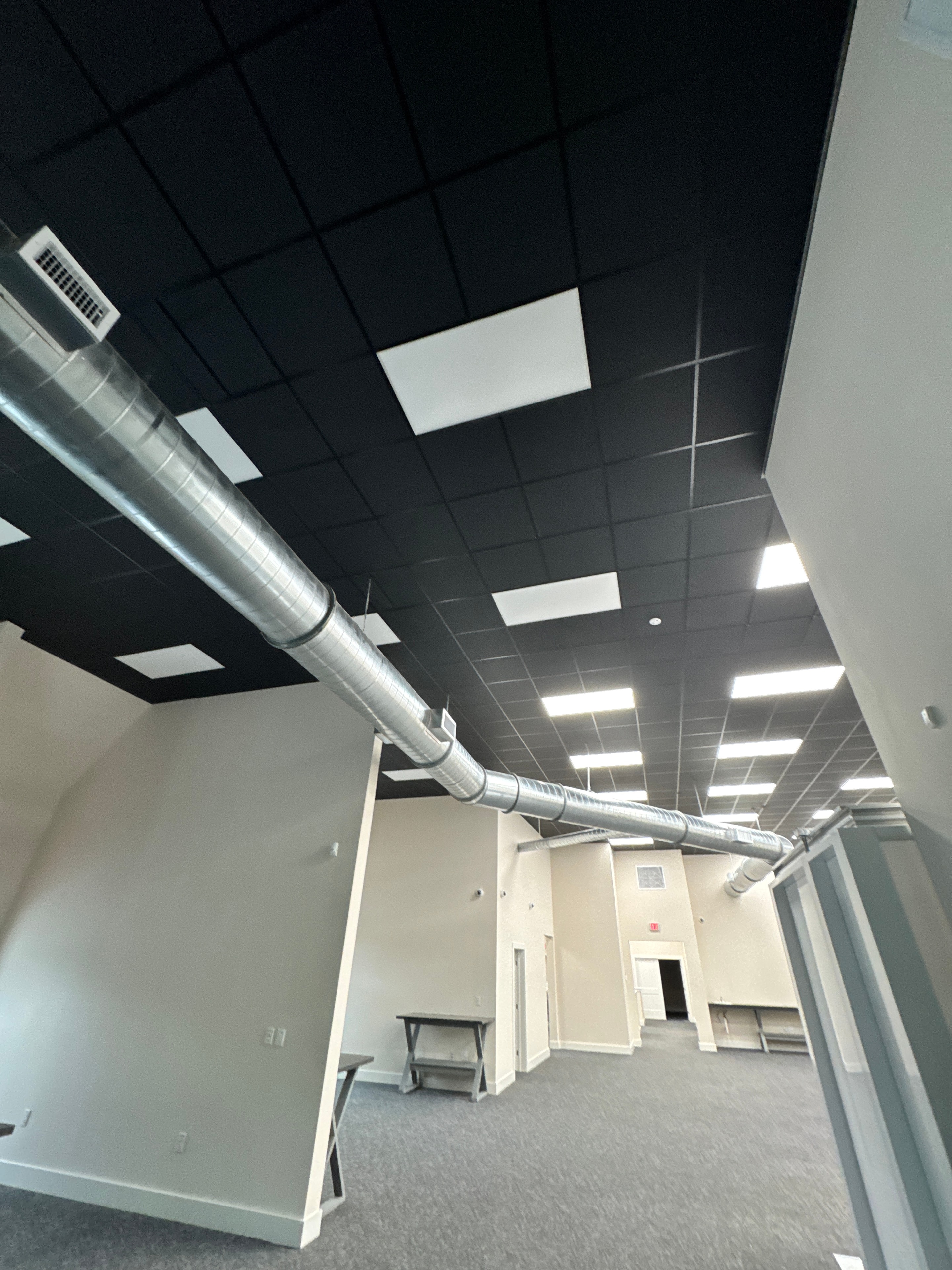 Commercial interior with exposed ductwork ceiling